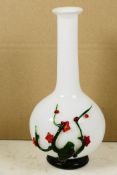 An unusual long necked white specimen vase with bulbous base, having applied decoration of a