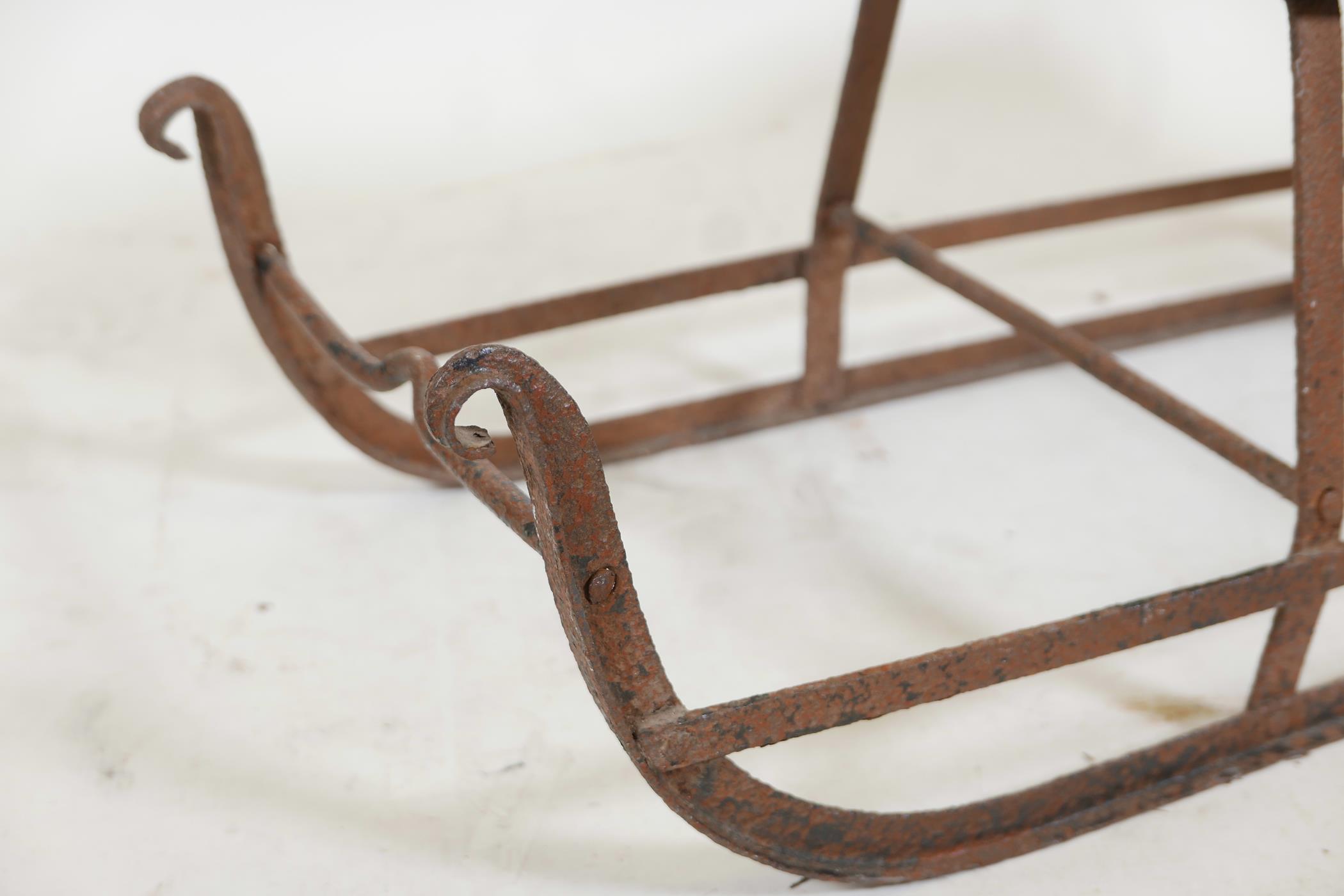 An antique child's sled, wrought iron with a wood seat, 32" x 20"high - Image 3 of 3