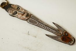 African tribal art - a ceremonial carved wood spear with animal and human heads painted in ochre and