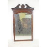 An Edwardian mahogany framed wall mirror adapted from a dressing table mirror with elaborately