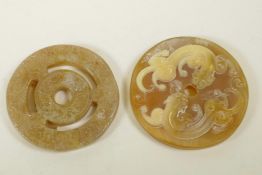 A Chinese carved horn pi disc pendant with kylin decoration and another hardstone carved and pierced