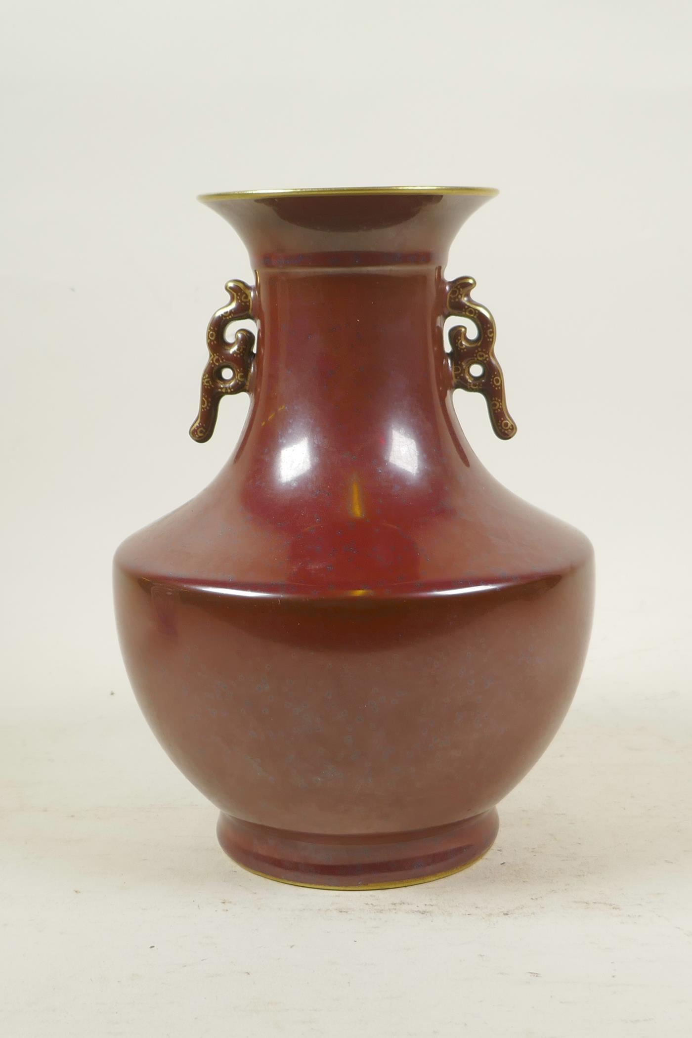 A Chinese copper glazed porcelain two handled vase with gilt details, impressed seal mark to base,