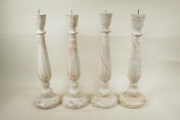 Two pairs of painted and distressed, turned wood pricket candlesticks, 19" high