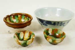 An Oriental blue and white stoneware bowl, 5¼" diameter, together with a Chinese Sancai rice bowl