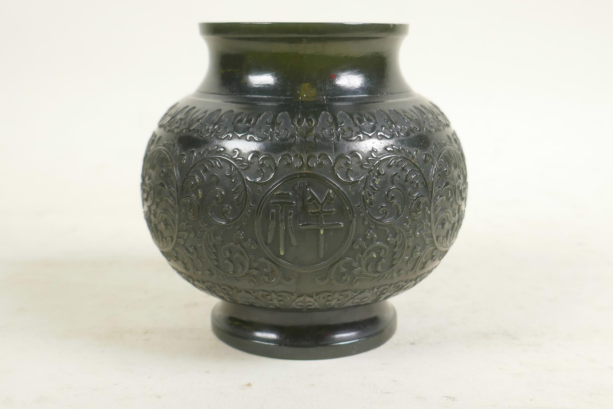 A Chinese spinach jade pot with carved scrolling lotus flower and character decoration, 4" high