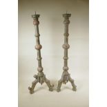 A pair of painted and distressed, turned wood, floor standing pricket candlesticks, A/F, 30½" high