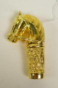 A gold plated metal cane handle in the form of a horse's head, 3½" long