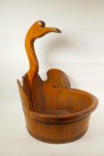 An Oriental hardwood bucket with handle in the form of a crane, 21½" high