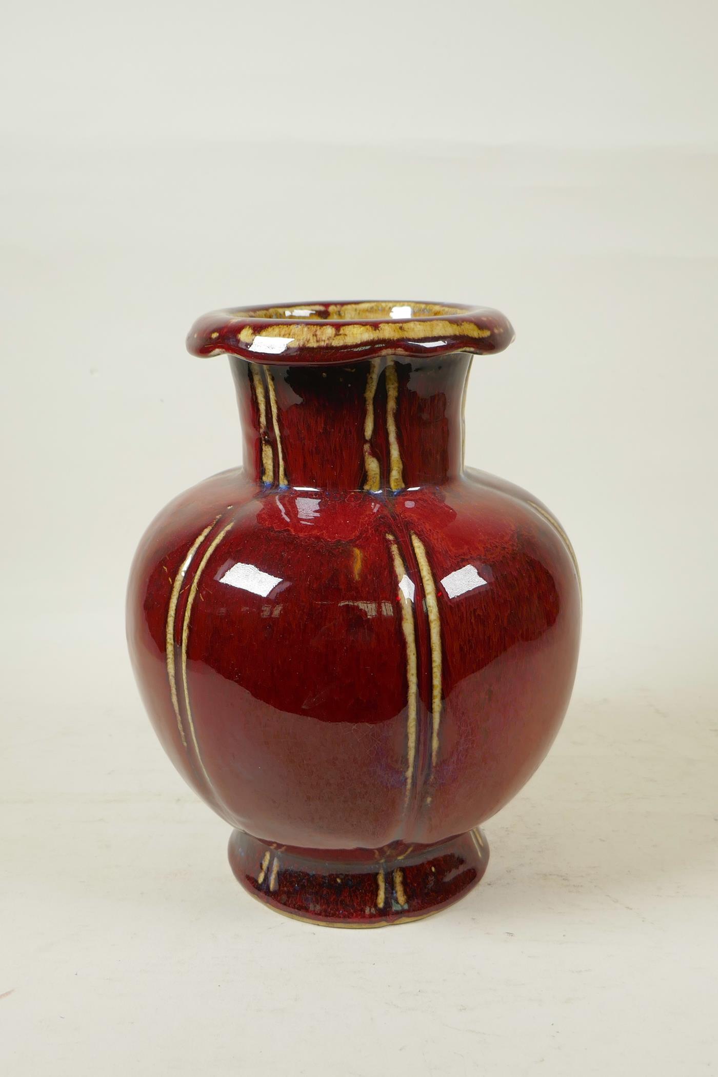 A Chinese flambe glazed pottery vase of ribbed form with a rolled rim, 9½" high - Image 3 of 4