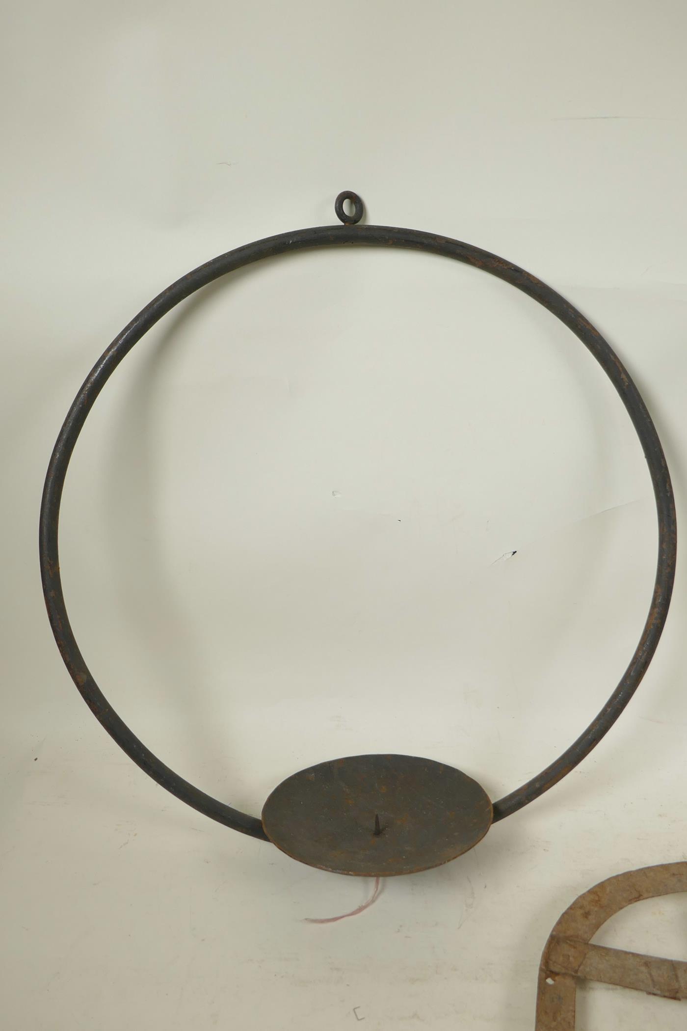 An Indian wrought iron hanging pricket candle holder, together with two riveted iron all bracket oil - Image 2 of 4