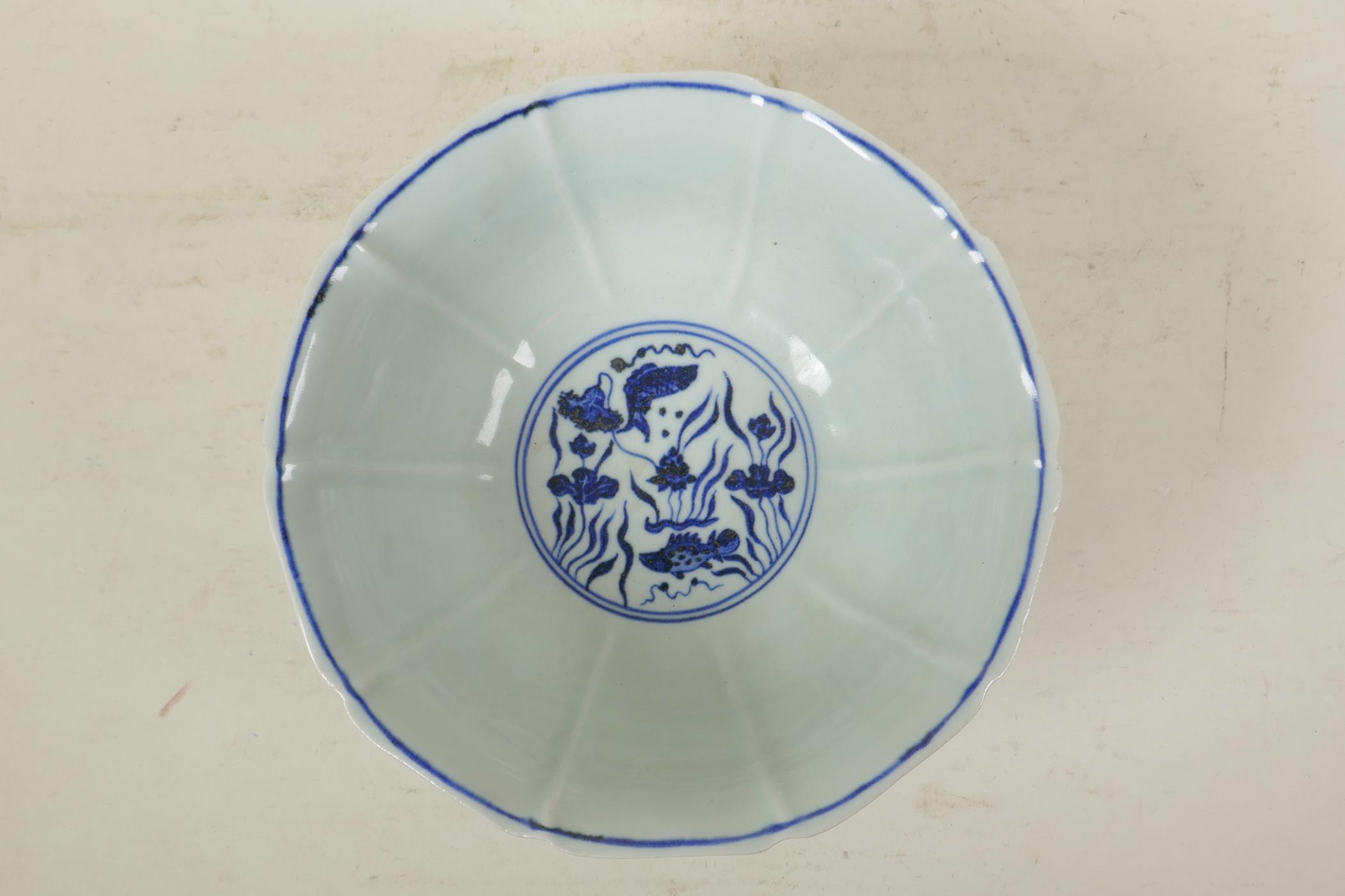 A Chinese Ming style blue and white porcelain bowl of lobed form, decorated with carp in a lotus - Image 6 of 7