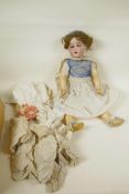 A C19th German doll with bisque head and articulated limbs having opening eyes and four teeth,
