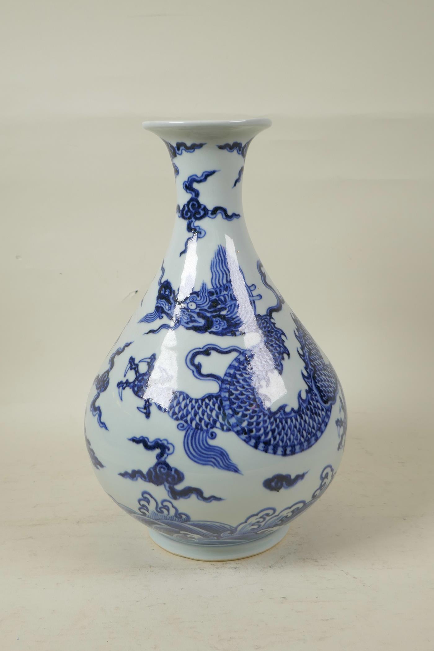 A Chinese blue and white porcelain pear shaped vase decorated with a dragon in flight, 12" high