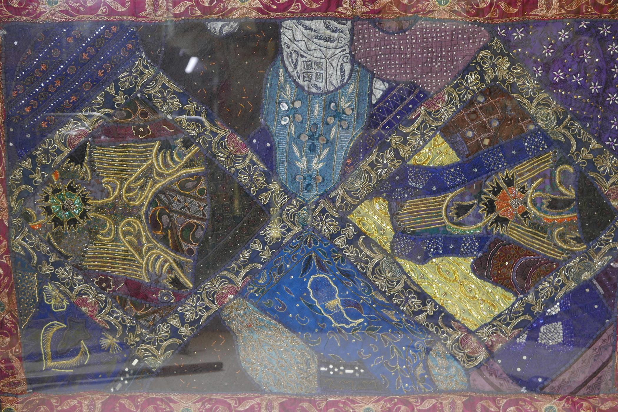 An Indo-Persian silk wall hanging with embroidered and beadwork decoration, framed, 64" x 44"