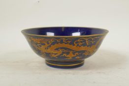 A Chinese powder blue ground porcelain bowl with coppered dragon decoration, 6 character mark to