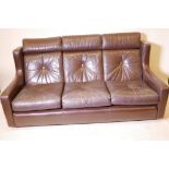 A contemporary three seater brown leather settee, 70" wide