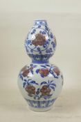 A Chinese blue and white porcelain double gourd vase, with iron red lotus flower and fruiting branch