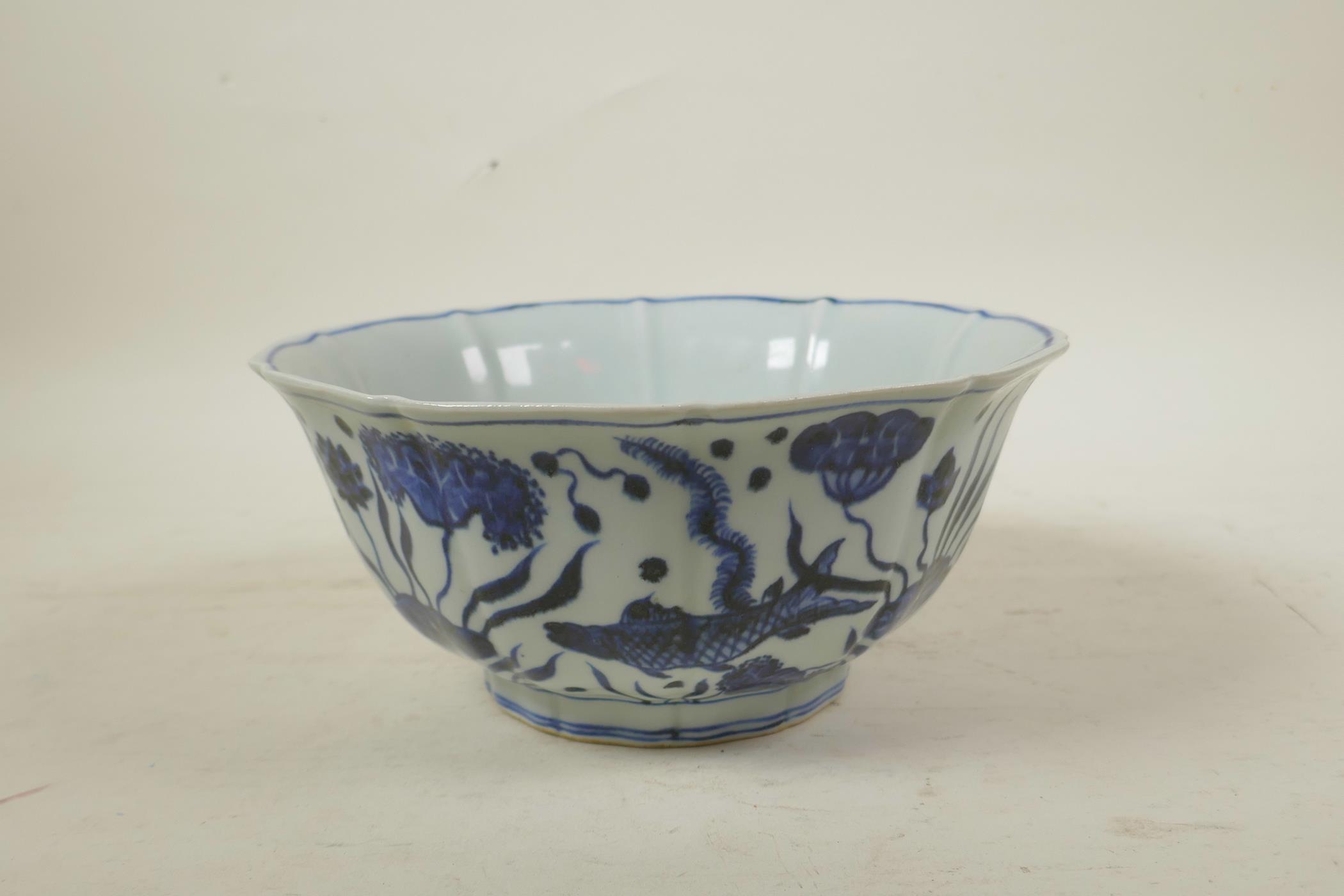 A Chinese Ming style blue and white porcelain bowl of lobed form, decorated with carp in a lotus - Image 3 of 7