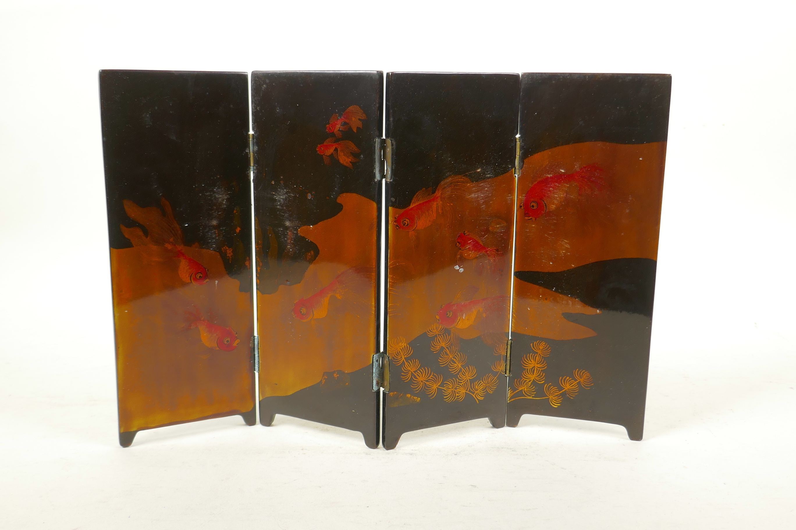 A Japanese lacquer four fold concertina table screen with goldfish decoration, each panel 3" x 8½"