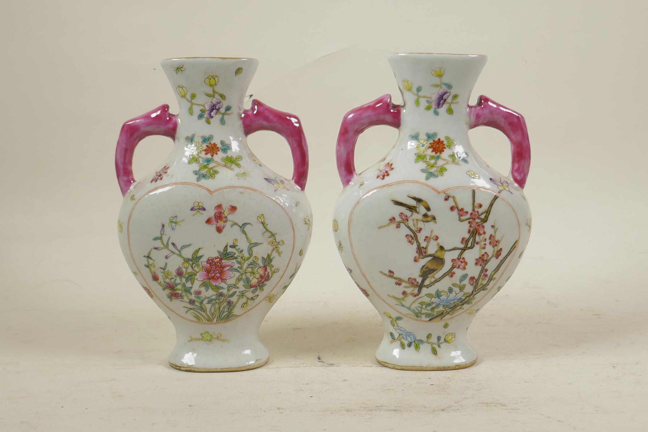 A pair of Chinese polychrome porcelain two handled vases with decorative heart shaped panels