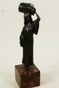 A cold painted bronze figure of an Arab water carrier, mounted on a square hardstone plinth, 7½"