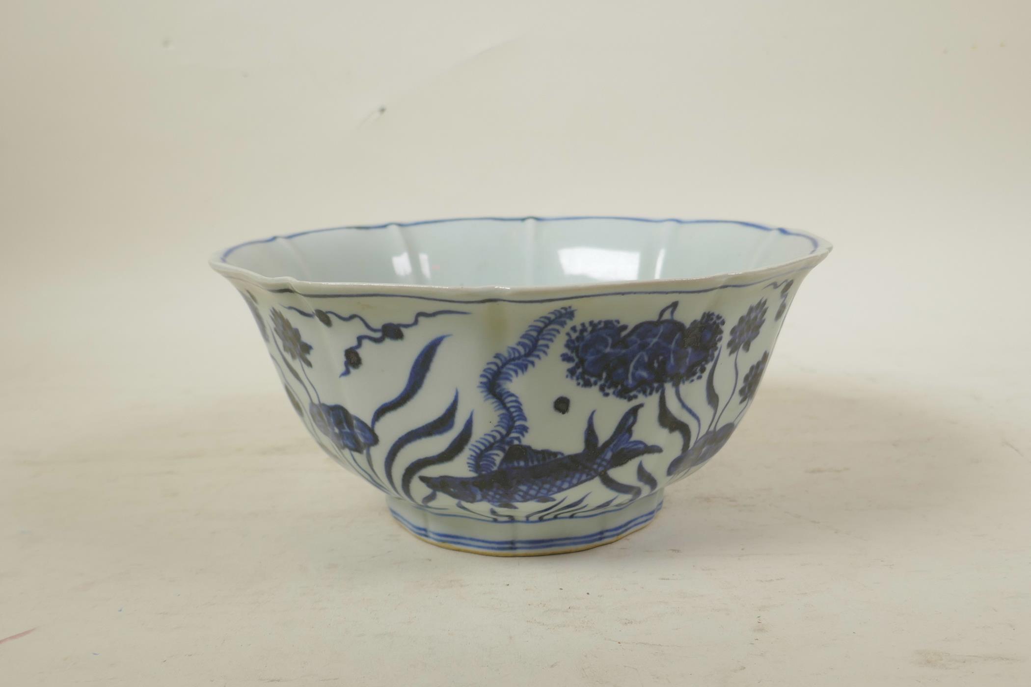 A Chinese Ming style blue and white porcelain bowl of lobed form, decorated with carp in a lotus