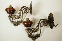 A pair of French, early C20th wall bracket lamps, well cast in scrolling brass with turned wooden