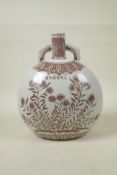 A Chinese Ming style red and white porcelain moon flask with two handles, decorated with flowers