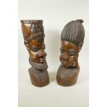 A pair of African carved hardwood head busts of a man and woman, 16" high
