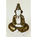 A Continental porcelain pastille burner modelled as a figure seated in meditation, 4" high