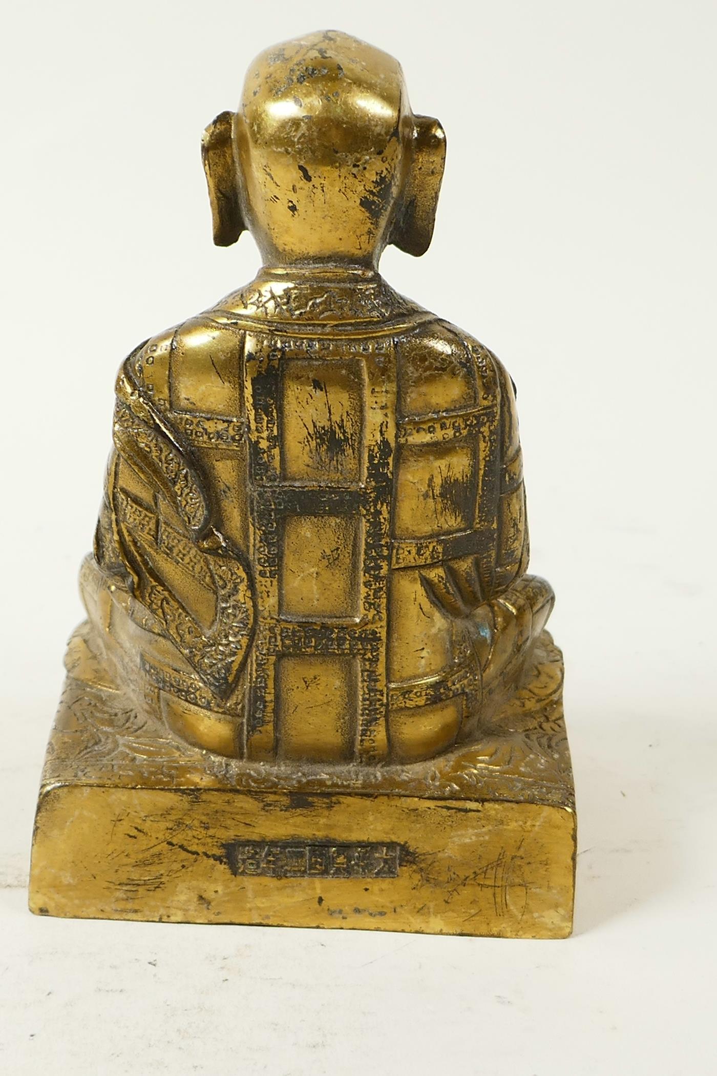 A Sino-Tibetan brass figure of Buddha seated in meditation having engraved decoration and set with - Image 4 of 5