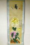 A Chinese silk embroidered scroll decoration with chrysanthemums, 10" x 35"