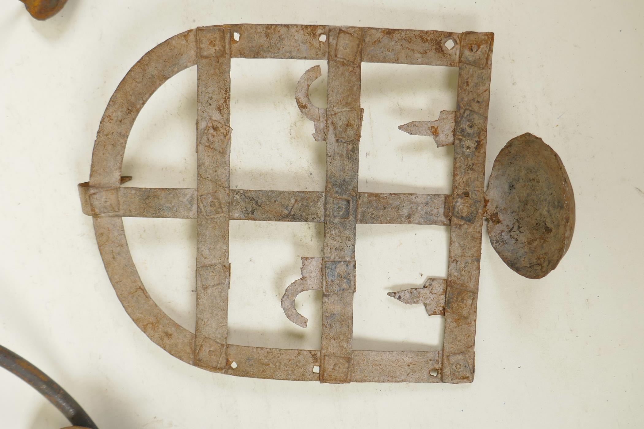 An Indian wrought iron hanging pricket candle holder, together with two riveted iron all bracket oil - Image 4 of 4