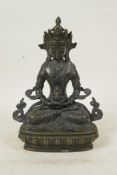 A Sino-Tibetan bronze of Buddha seated on a lotus throne, 9" high