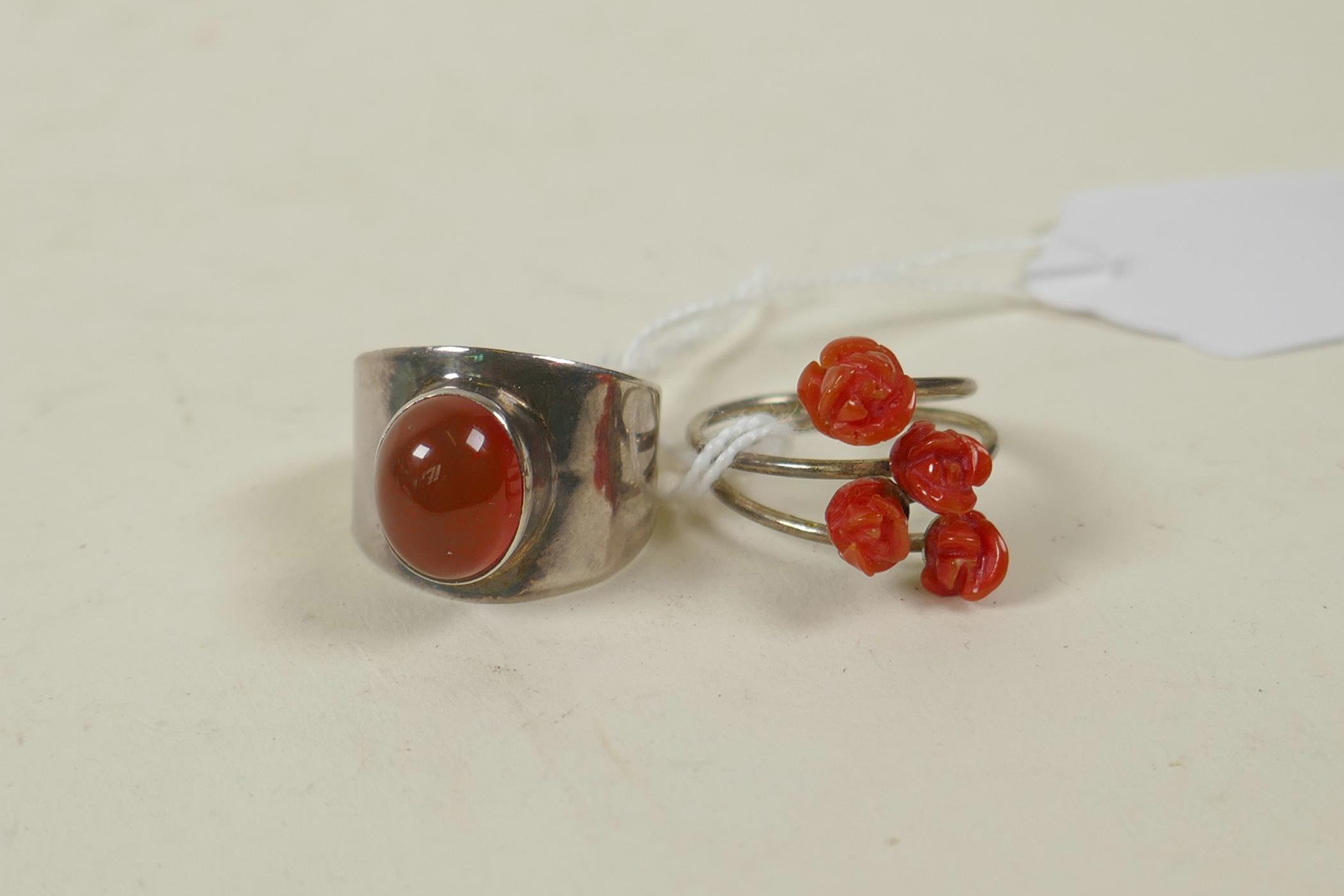 A retro 925 silver and carnelian set ring, and a silver crossover ring set with coral carved in