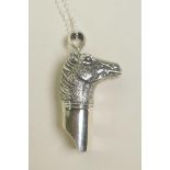 A sterling silver pendant whistle in the form of a horse head, 1½"