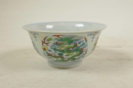 A Chinese doucai porcelain tea bowl, decorated with a dragon chasing the flaming pearl, 6