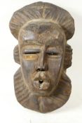 African tribal art, a carved wood mask, 15" long