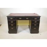 A Victorian walnut pedestal desk, with nine moulded front drawers, and brass plate handles and inset