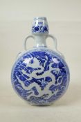 A Chinese Ming style blue and white porcelain garlic head shaped flask with two handles, decorated