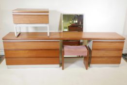 A 1970s modular teak topped dressing table with six drawers, and a matching single draw bedside