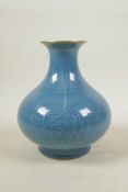 A Chinese duck egg blue glazed porcelain vase with underglaze decoration depicting branches
