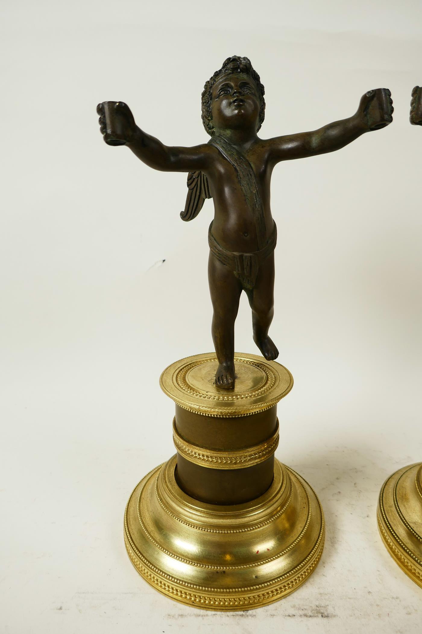 A pair of bronze cherubs cast with outstretched arms mounted on French marble and ormolu Empire - Image 3 of 5