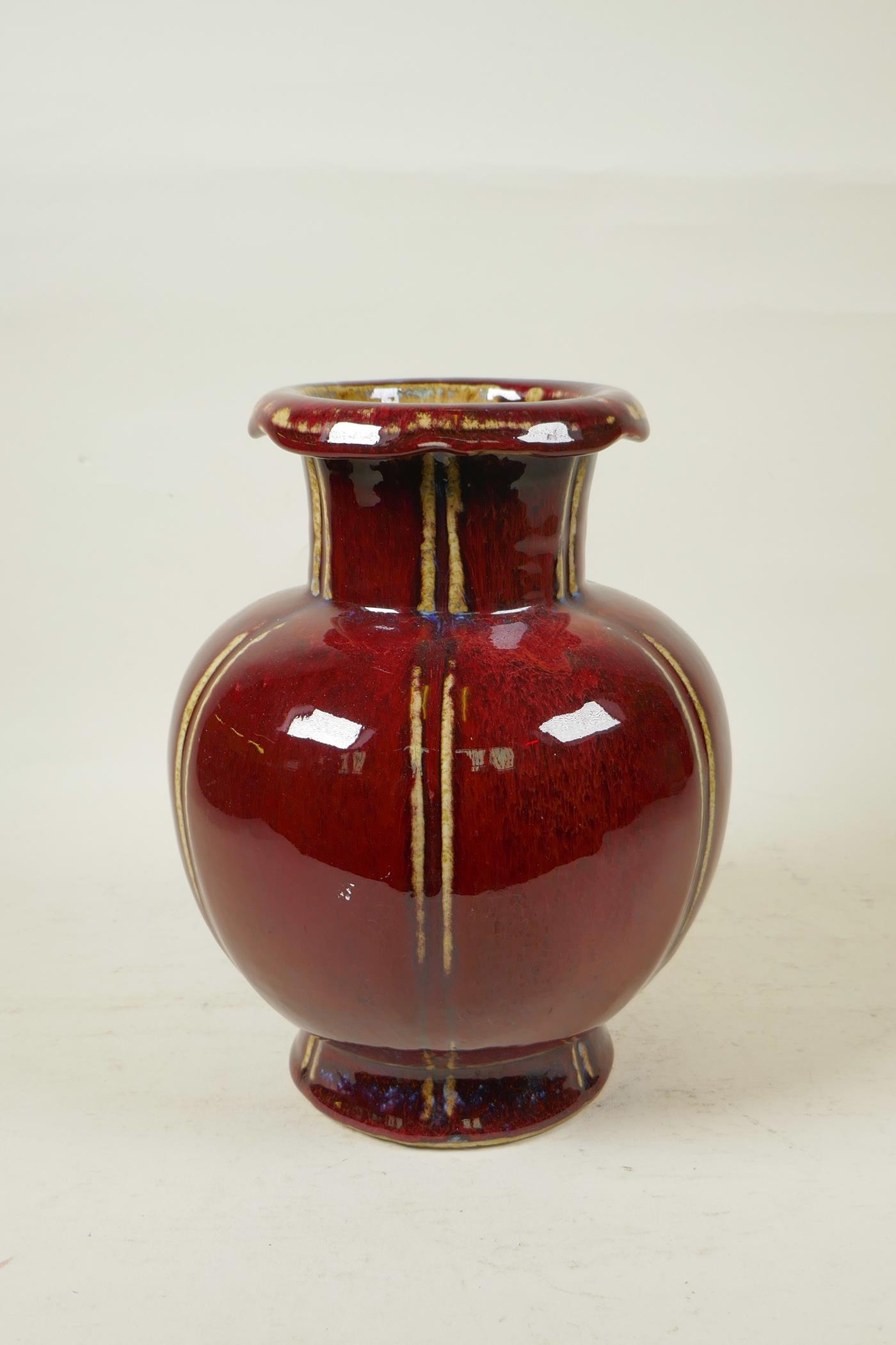 A Chinese flambe glazed pottery vase of ribbed form with a rolled rim, 9½" high - Image 2 of 4