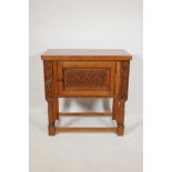 A late C19th/earlyC20th oak side cabinet with a carved panel door and beaded frieze, 30" x 16",