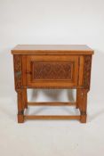 A late C19th/earlyC20th oak side cabinet with a carved panel door and beaded frieze, 30" x 16",