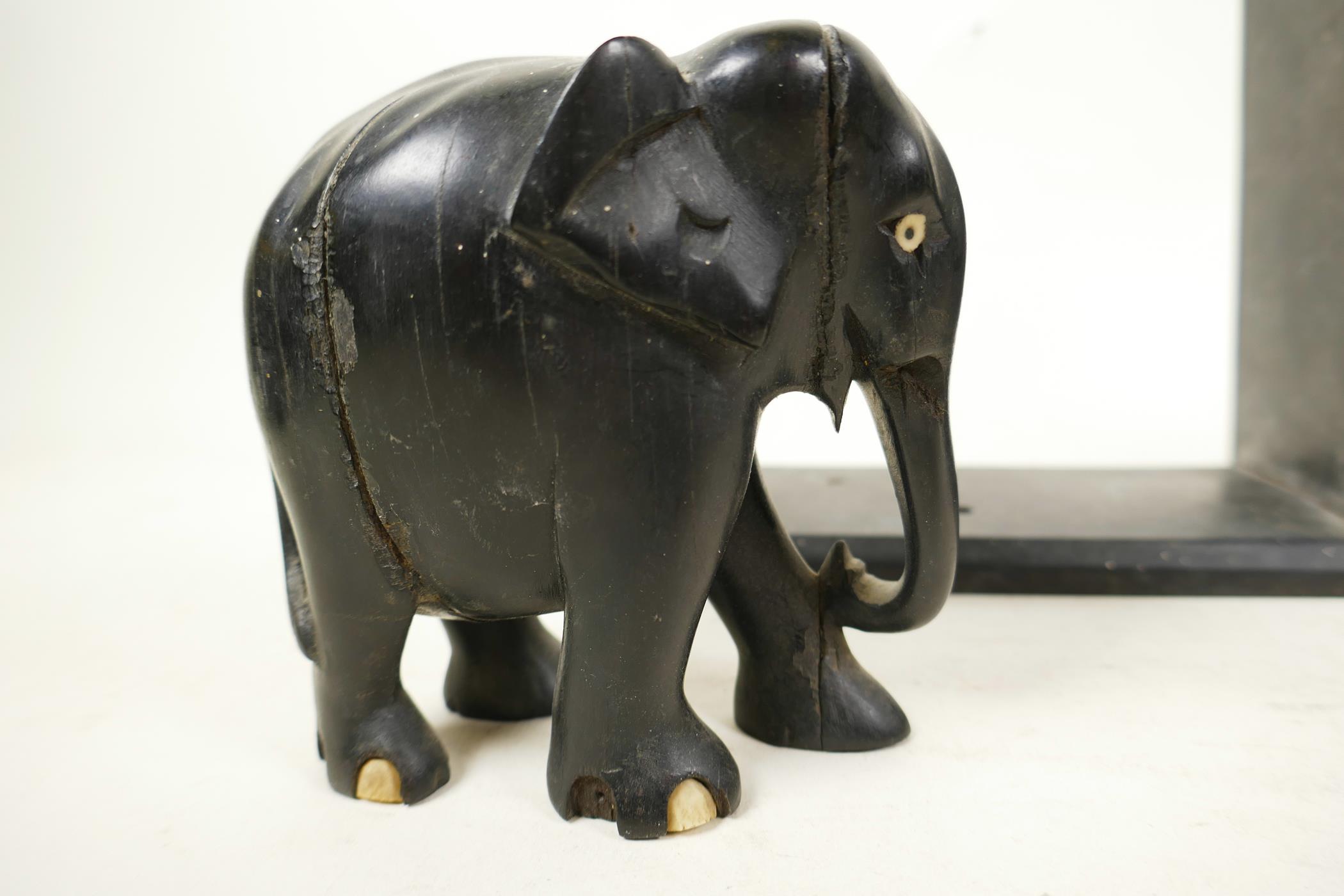 A pair of early C20th ebony carved elephant bookends, one detached from stand, 6" high x 6½" wide, - Image 3 of 8