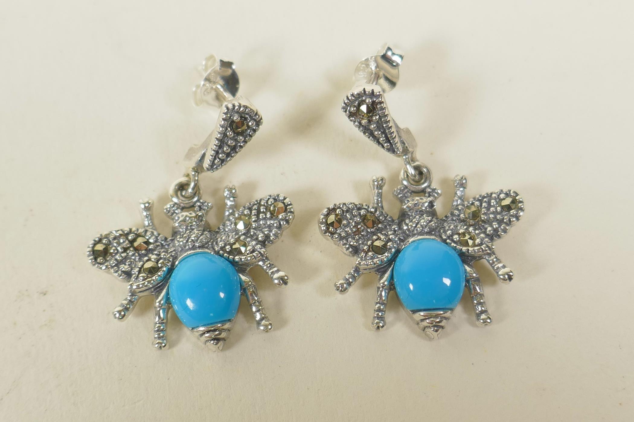 A pair of silver, marcasite and turquoise set drop earrings in the form of winged insects, 1" drop