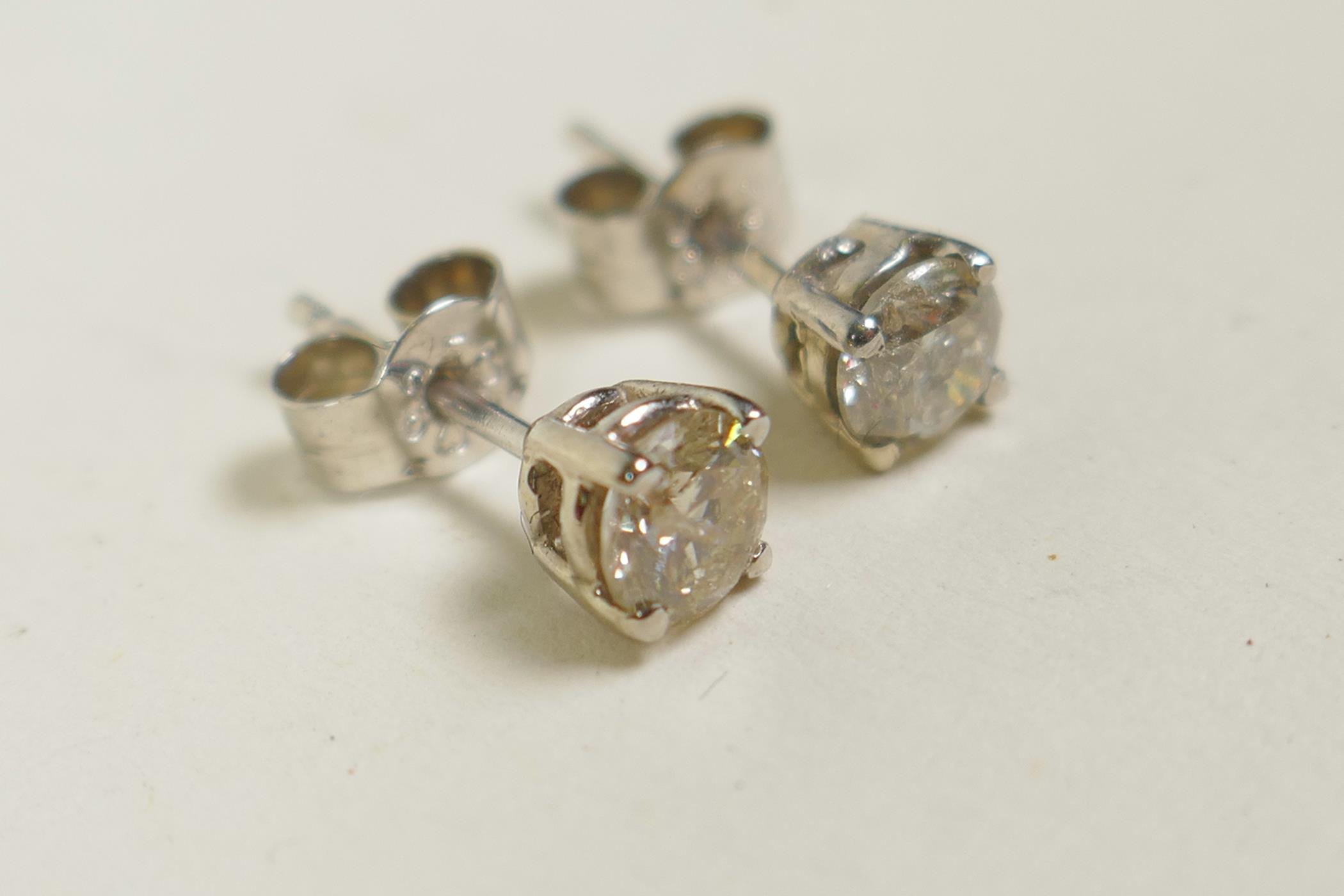 A pair of 14ct white gold diamond stud earrings, 64 points - Image 2 of 2