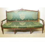 A late C19th/early C20th Italian walnut showframe, open arm settee, with carved crest and finials
